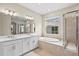 Well-appointed bathroom featuring double sinks, soaking tub, and walk-in shower at 9292 Tequila Sunrise Dr, Sarasota, FL 34241