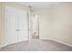 Bedroom view featuring white walls, carpet, closet, and access to the en-suite bathroom at 9292 Tequila Sunrise Dr, Sarasota, FL 34241