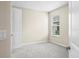 Cozy bedroom features neutral walls, bright window with blinds, and neutral carpet at 9292 Tequila Sunrise Dr, Sarasota, FL 34241