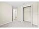 View of bedroom featuring large closet and bathroom entrance with neutral walls and carpet at 9292 Tequila Sunrise Dr, Sarasota, FL 34241