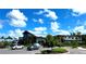 The clubhouse is surrounded by lush landscaping and parking at 9292 Tequila Sunrise Dr, Sarasota, FL 34241