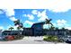 Modern clubhouse with contemporary architecture, manicured landscaping, and ample parking at 9292 Tequila Sunrise Dr, Sarasota, FL 34241