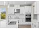Bright kitchen features stainless steel appliances, a large island and pendant lights at 9292 Tequila Sunrise Dr, Sarasota, FL 34241