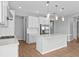Modern kitchen with white cabinetry, stainless steel appliances, a large island and pendant lighting at 9292 Tequila Sunrise Dr, Sarasota, FL 34241