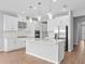 Modern kitchen featuring an island with bar seating, stainless steel appliances and modern pendant lights at 9292 Tequila Sunrise Dr, Sarasota, FL 34241