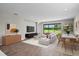 Bright and airy living room featuring wood-look floors, a large sliding glass door and views of the backyard at 9292 Tequila Sunrise Dr, Sarasota, FL 34241
