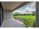 View of a backyard from the covered lanai, with lush green grass and landscaping at 9292 Tequila Sunrise Dr, Sarasota, FL 34241