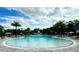 Resort-style pool with cabanas, palm trees, lounge chairs, and water slide at 9292 Tequila Sunrise Dr, Sarasota, FL 34241