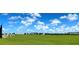 Expansive community soccer field with lush green grass and a clear blue sky with light clouds at 9292 Tequila Sunrise Dr, Sarasota, FL 34241