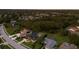 An aerial view showcases a well-planned suburban neighborhood, featuring green lawns, pools, and houses nestled among mature trees at 10022 Laurel Valley Avenue Cir, Bradenton, FL 34202