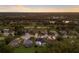 An aerial view shows a residential neighborhood with well-maintained homes, swimming pools, and lush landscaping near a golf course at 10022 Laurel Valley Avenue Cir, Bradenton, FL 34202