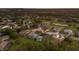 An aerial view shows a residential neighborhood near a golf course, featuring well-maintained homes and lush landscaping at 10022 Laurel Valley Avenue Cir, Bradenton, FL 34202