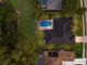 Aerial view of a house with a screened-in pool and lush landscaping at 10022 Laurel Valley Avenue Cir, Bradenton, FL 34202