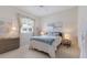 Well-lit bedroom with neutral walls, stylish decor, and ceiling fan at 10022 Laurel Valley Avenue Cir, Bradenton, FL 34202