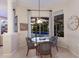 Cozy breakfast nook with a round glass table and comfortable chairs, bathed in natural light with a view of the pool at 10022 Laurel Valley Avenue Cir, Bradenton, FL 34202