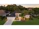Well-maintained single Gathering home with a lush lawn and palm trees, presenting a welcoming and inviting exterior at 10022 Laurel Valley Avenue Cir, Bradenton, FL 34202