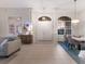 Bright foyer with a glimpse of the dining and living areas, complemented by tile flooring and natural lighting at 10022 Laurel Valley Avenue Cir, Bradenton, FL 34202