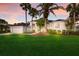 Charming single-story home with well-manicured lawn and lush landscaping, complemented by palm trees and a two-car garage at 10022 Laurel Valley Avenue Cir, Bradenton, FL 34202