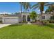 Charming single-story home boasts a well-manicured lawn and lush landscaping with beautiful palm trees at 10022 Laurel Valley Avenue Cir, Bradenton, FL 34202