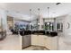 Bright, modern kitchen features an island with granite counters and stainless steel appliances at 10022 Laurel Valley Avenue Cir, Bradenton, FL 34202