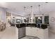 Modern kitchen with granite countertops, stainless steel appliances, and a breakfast bar overlooking the living spaces at 10022 Laurel Valley Avenue Cir, Bradenton, FL 34202