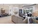 Open-concept living area with a sofa, dining space, and serene views of the outdoors at 10022 Laurel Valley Avenue Cir, Bradenton, FL 34202