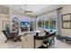 Cozy living room boasts a fireplace, built-in shelving, and views of the private pool area at 10022 Laurel Valley Avenue Cir, Bradenton, FL 34202