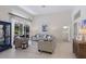 Bright living room with comfortable seating, sliding glass doors to the lanai, and serene views at 10022 Laurel Valley Avenue Cir, Bradenton, FL 34202