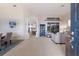 Open-concept living area with tile flooring, neutral colors, and bright natural light from large windows overlooking the lanai at 10022 Laurel Valley Avenue Cir, Bradenton, FL 34202