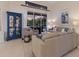 Comfortable living space with plush seating, stylish decor, and a view of the outdoor pool area through sliding glass doors at 10022 Laurel Valley Avenue Cir, Bradenton, FL 34202