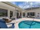 Inviting outdoor living space featuring a screened-in pool, patio, and seating at 10022 Laurel Valley Avenue Cir, Bradenton, FL 34202