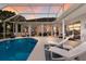 A screened-in pool area boasts clear blue water and plenty of lounging options, accessible from multiple rooms at 10022 Laurel Valley Avenue Cir, Bradenton, FL 34202