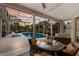 Covered patio with seating area overlooking the pool, ideal for outdoor relaxation and entertaining at 10022 Laurel Valley Avenue Cir, Bradenton, FL 34202