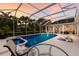 A refreshing screened pool and spa are showcased with seating areas, perfect for outdoor relaxation and entertaining at 10022 Laurel Valley Avenue Cir, Bradenton, FL 34202