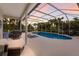 Enclosed pool area with spa and ample seating, enhanced by lush greenery for added privacy at 10022 Laurel Valley Avenue Cir, Bradenton, FL 34202