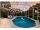 Secluded pool with sun loungers, surrounded by a screened enclosure, ensuring privacy and relaxation at 10022 Laurel Valley Avenue Cir, Bradenton, FL 34202