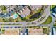 Birds-eye view of community featuring a pool, landscaped grounds, pond and modern townhome exteriors at 10037 62Nd N Ter # 23, St Petersburg, FL 33708