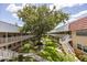 Aerial view of condo complex featuring manicured lawns, mature trees, walkways and exterior stairways at 10037 62Nd N Ter # 23, St Petersburg, FL 33708