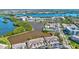 Panoramic aerial view of the townhomes with lakeside frontage and lush greenery in a waterfront community at 10037 62Nd N Ter # 23, St Petersburg, FL 33708