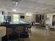 Spacious bar area with seating, dark bar, television, and tables near a window and door at 10037 62Nd N Ter # 23, St Petersburg, FL 33708