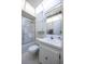 Bright bathroom featuring swan art shower door, white cabinets, toilet and skylight at 10037 62Nd N Ter # 23, St Petersburg, FL 33708