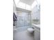 Bathroom features swan etched glass shower doors and a storage cabinet at 10037 62Nd N Ter # 23, St Petersburg, FL 33708