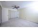 Bedroom with ceiling fan, closet, and neutral carpeting at 10037 62Nd N Ter # 23, St Petersburg, FL 33708