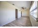 Inviting room with a ceiling fan, laminate floors, neutral paint, and a large window at 10037 62Nd N Ter # 23, St Petersburg, FL 33708