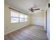 Sun-filled room features a ceiling fan, laminate floors, neutral paint, and a bright window at 10037 62Nd N Ter # 23, St Petersburg, FL 33708