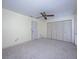 Bedroom with ceiling fan, closet, and neutral carpeting at 10037 62Nd N Ter # 23, St Petersburg, FL 33708