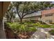 Exterior view of condo complex highlighting mature trees, walkways, landscaping and exterior stairways at 10037 62Nd N Ter # 23, St Petersburg, FL 33708