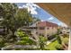 View of condo complex featuring mature trees, landscaping, walking paths, and exterior stairways at 10037 62Nd N Ter # 23, St Petersburg, FL 33708