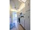 Bright kitchen featuring wood-look floors, white cabinets, and modern appliances at 10037 62Nd N Ter # 23, St Petersburg, FL 33708