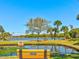 Scenic pond view with benches and mature landscaping, creating a peaceful atmosphere at 10037 62Nd N Ter # 23, St Petersburg, FL 33708